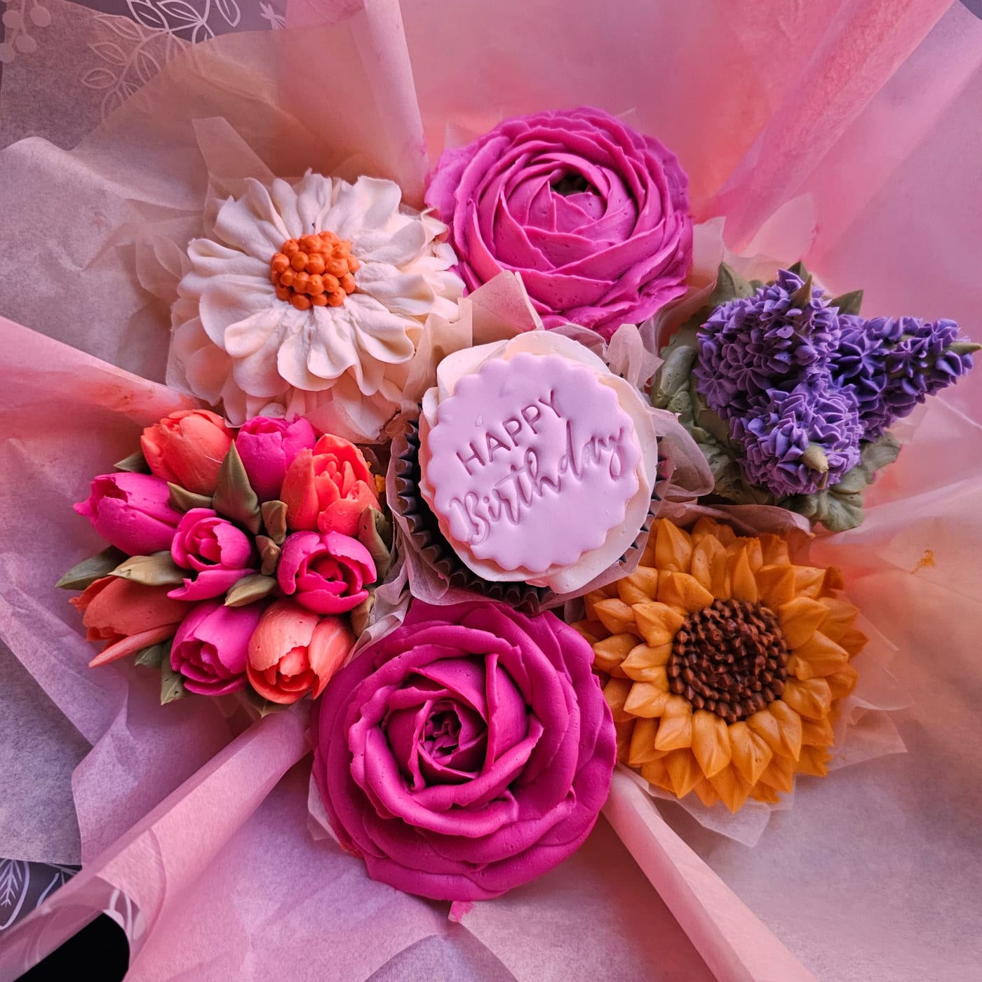 Multi-coloured floral cupcake bouquet by Amour Desserts